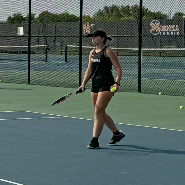 Senior Courteney Cranston warms up before facing Bolingbrook on Sept. 10. Cranston is a first singles player for Minooka, and she won her match against Bolingbrook. 