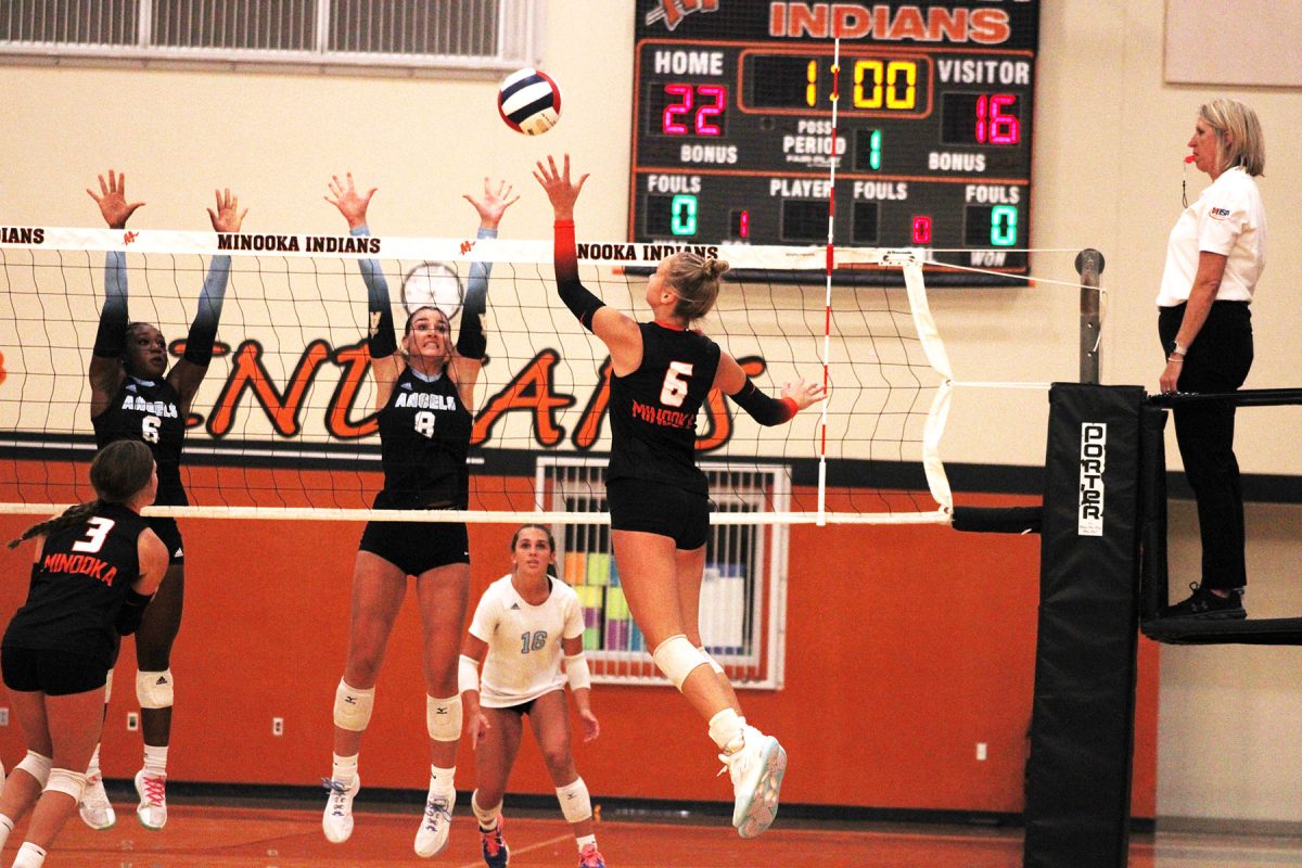 Junior Kendall Kozak knocks the ball over the net in the win over Joliet Catholic on Sept. 4.