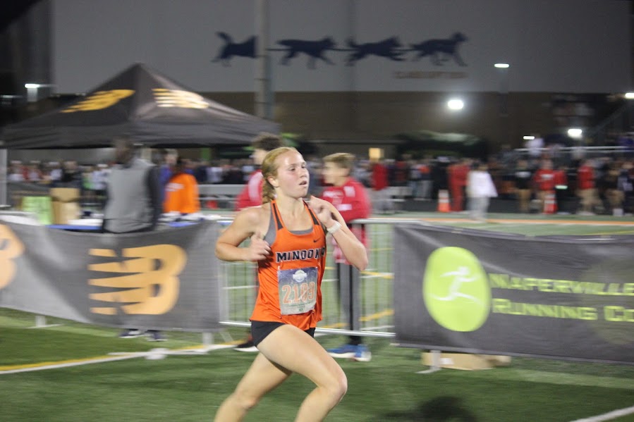 Freshman Clara Getsoian runs at the Naperville Twilight Invite on Oct. 31 when she ran a personal best for 3 miles.  She is also an all-conference runner for Minooka. 