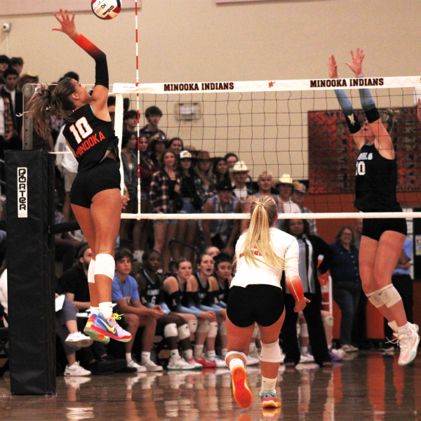 Sophomore Courtney Walter goes up for a hit against Joliet Catholic at an early season game. 